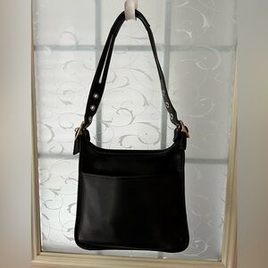 Vintage Coach Legacy zip bag in black leather, gold antique tone hardware, feet.